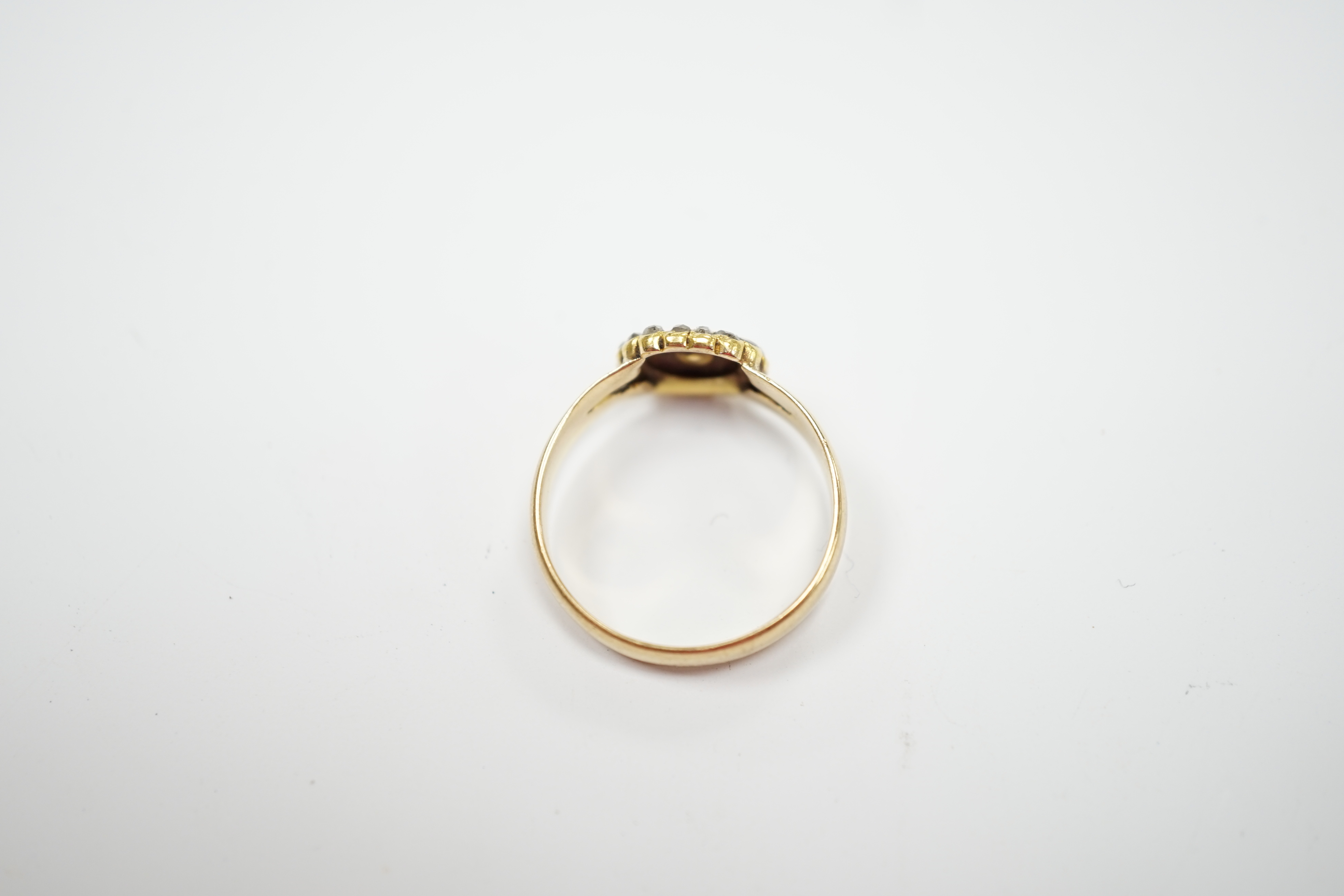 An Edwardian 18ct gold, rose cut diamond and split pearl cluster set ring, size O, gross weight 3.2 grams.